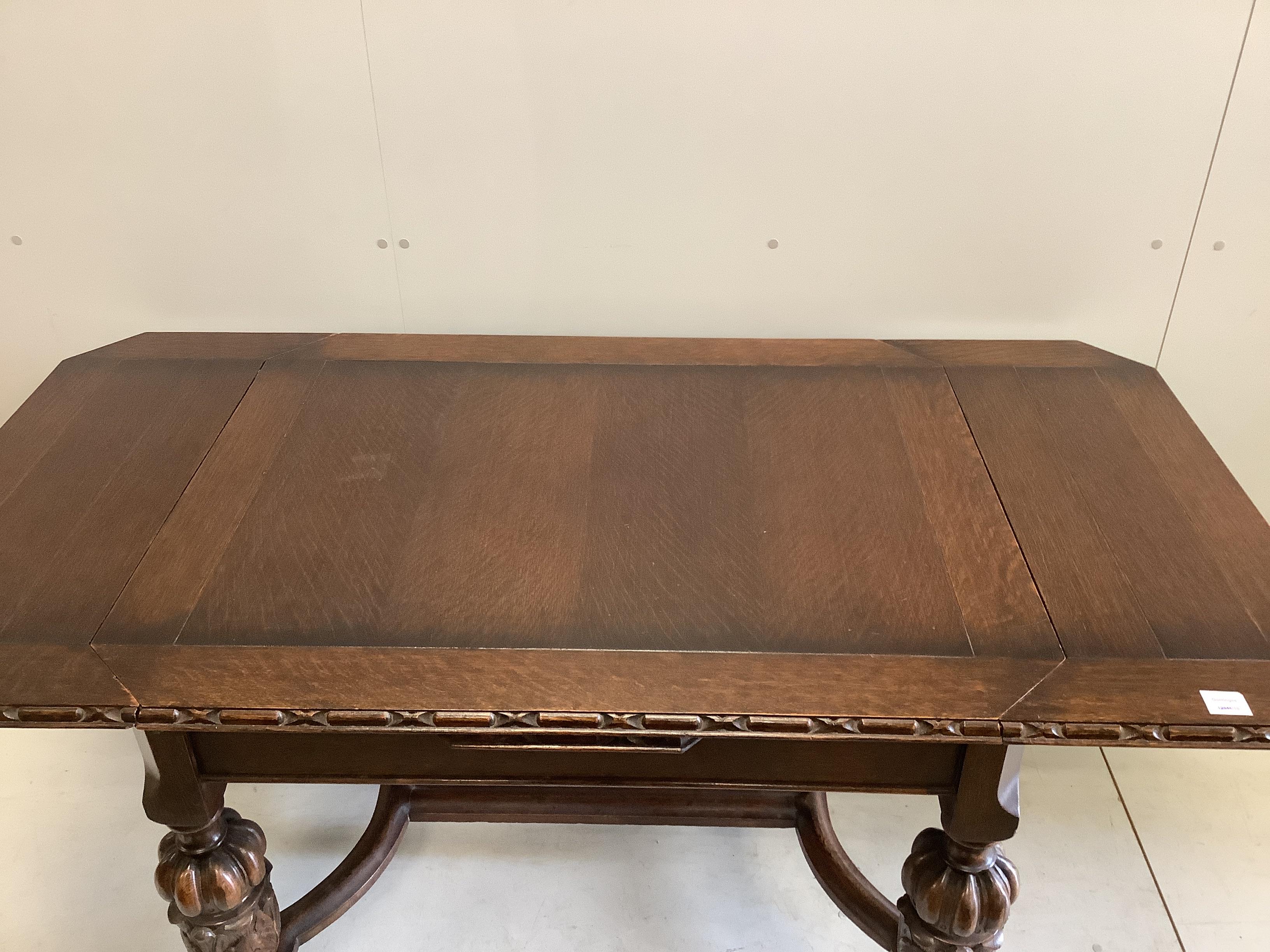 A Jacobean Revival oak draw leaf dining table, width 168cm extended, depth 83cm, height 76cm together with four matching single chairs